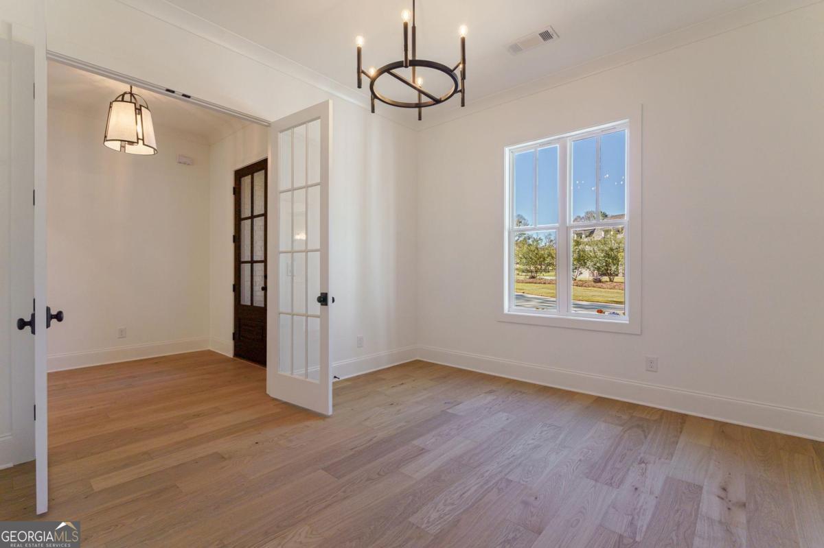 140 Parkside Lane Eatonton, GA 31024 - Photo 7 of 37 a view of an empty room with wooden floor and window