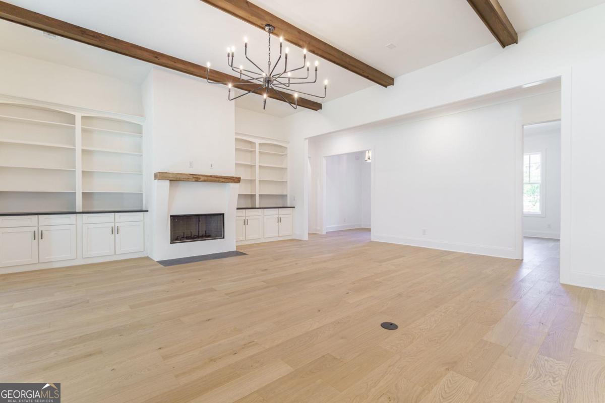 140 Parkside Lane Eatonton, GA 31024 - Photo 10 of 37 a view of empty room with wooden floor and fireplace