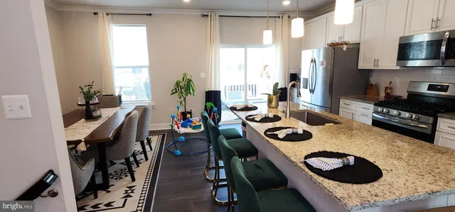 a kitchen with a sink a stove and a refrigerator