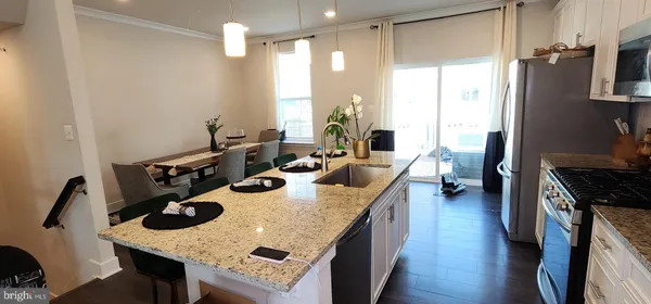 a kitchen with sink stove and refrigerator