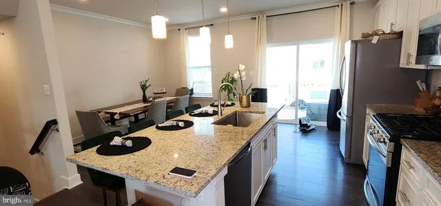 a kitchen with sink stove and refrigerator