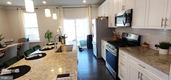 a kitchen with sink refrigerator and stove