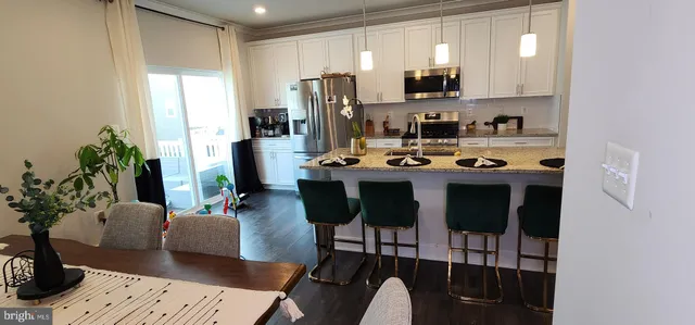 a view of a dining room with furniture and a potted plant