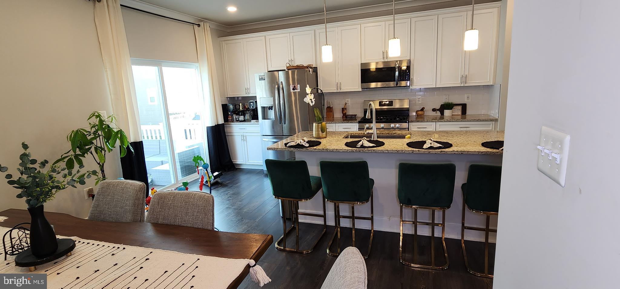 2 2nd, Unit 201 Lewes, DE 19958 - Photo 19 of 48 a view of a dining room with furniture and a potted plant
