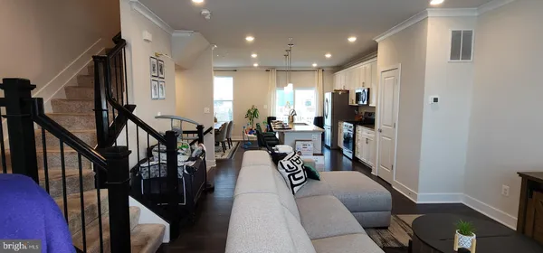 a living room with lots of furniture and wooden floor