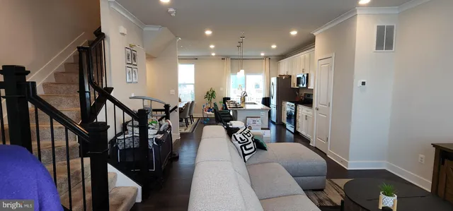 a living room with lots of furniture and wooden floor