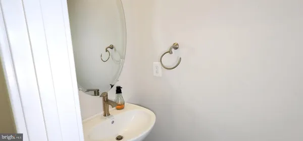 a bathroom with a sink and mirror