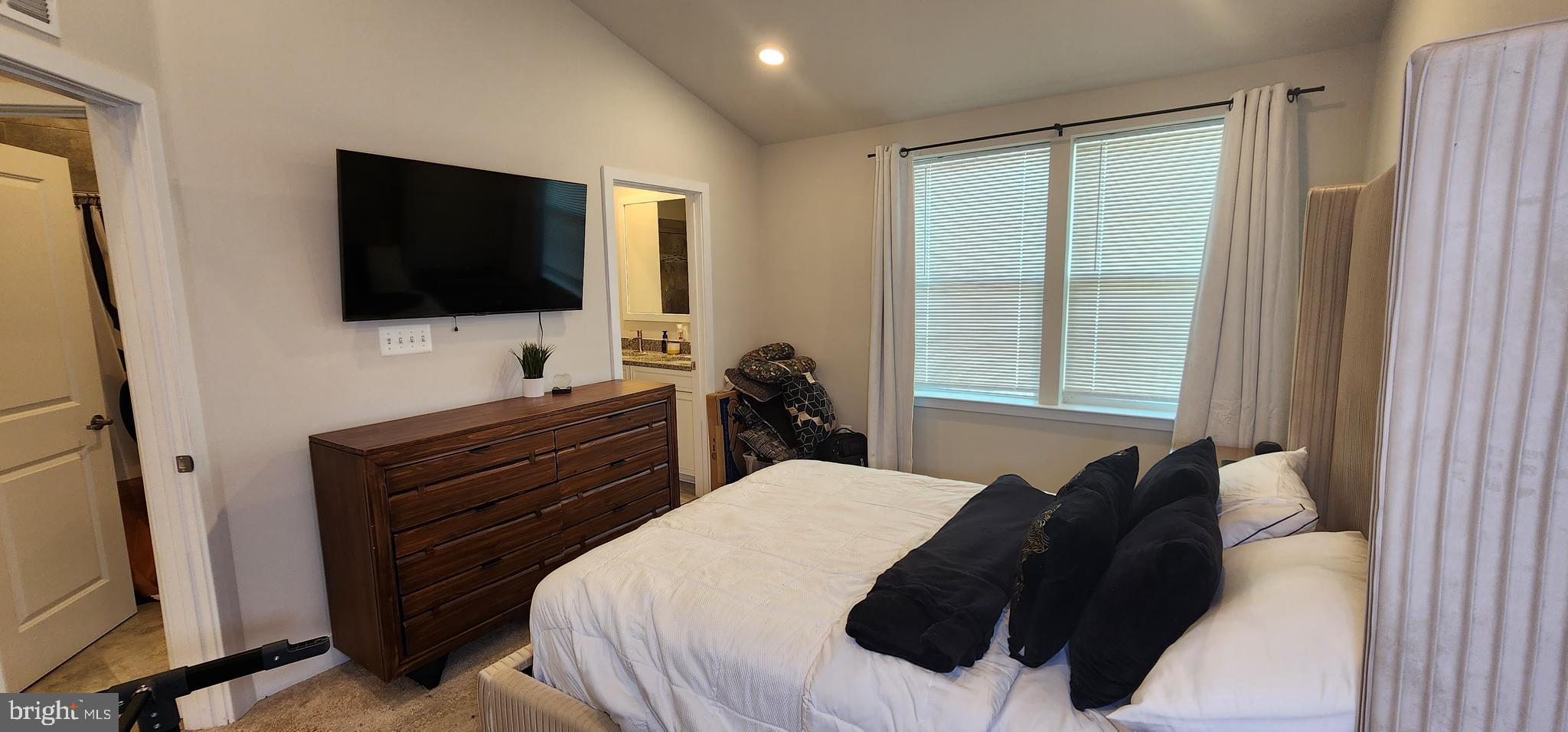 2 2nd, Unit 201 Lewes, DE 19958 - Photo 36 of 48 a bedroom with a bed and a flat tv screen on dresser
