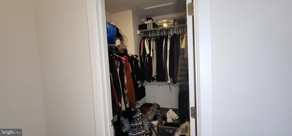a bedroom with a bed and a flat tv screen on wall