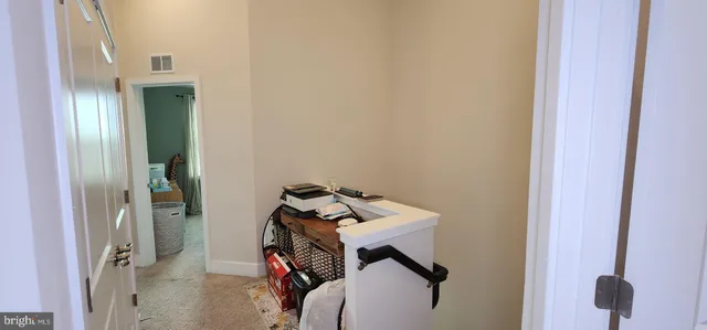 a view of a room with furniture and windows