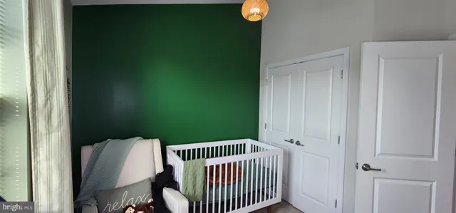 a bedroom with a large bed and a potted plant