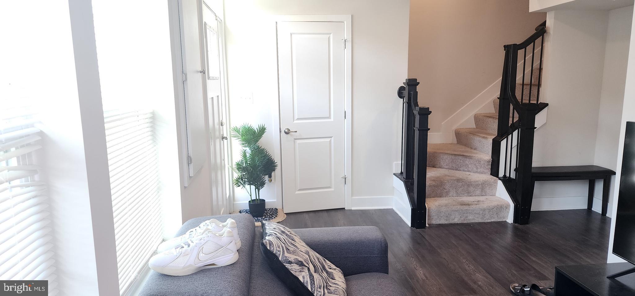 2 2nd, Unit 201 Lewes, DE 19958 - Photo 5 of 48 a living room with furniture and a potted plant