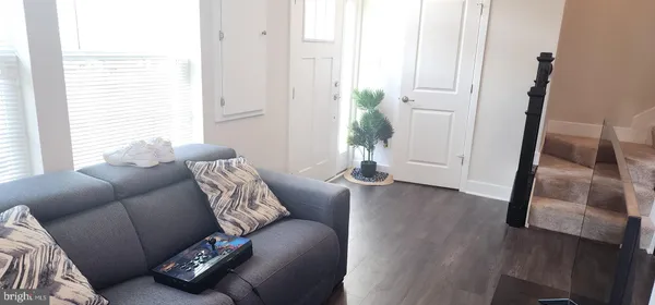 a living room with furniture and a potted plant