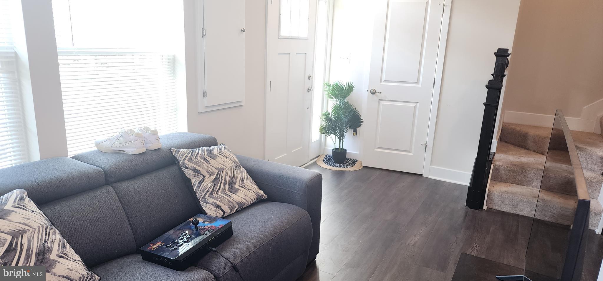 2 2nd, Unit 201 Lewes, DE 19958 - Photo 6 of 48 a living room with furniture and a potted plant