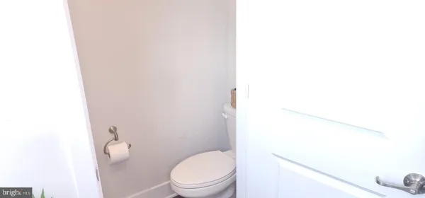 a white toilet sitting next to a shower