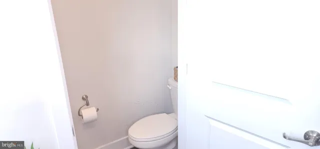 a white toilet sitting next to a shower