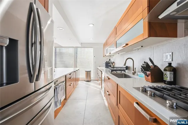 a kitchen with stainless steel appliances granite countertop a stove and a sink