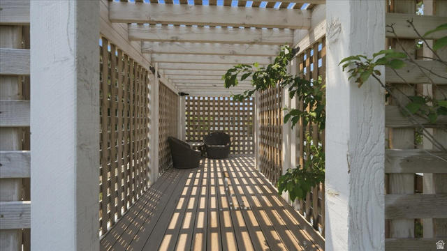 2038 East Ranch Road Eagle Mountain, UT 84005 - Photo 56 of 66 Pergola-covered walkway featuring a slatted roof, lattice side panels, and composite decking