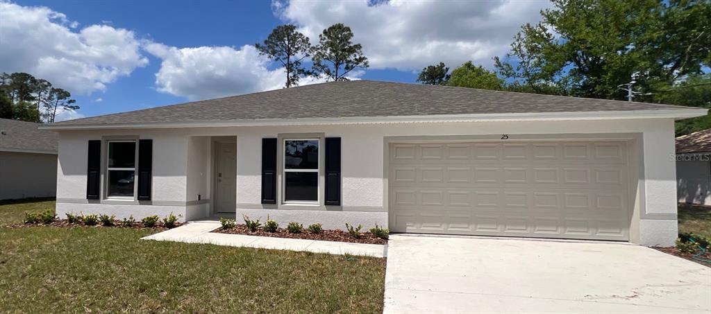 25 Ryding Lane Palm Coast, FL 32164 - Photo 1 of 13 front view of a house with a yard