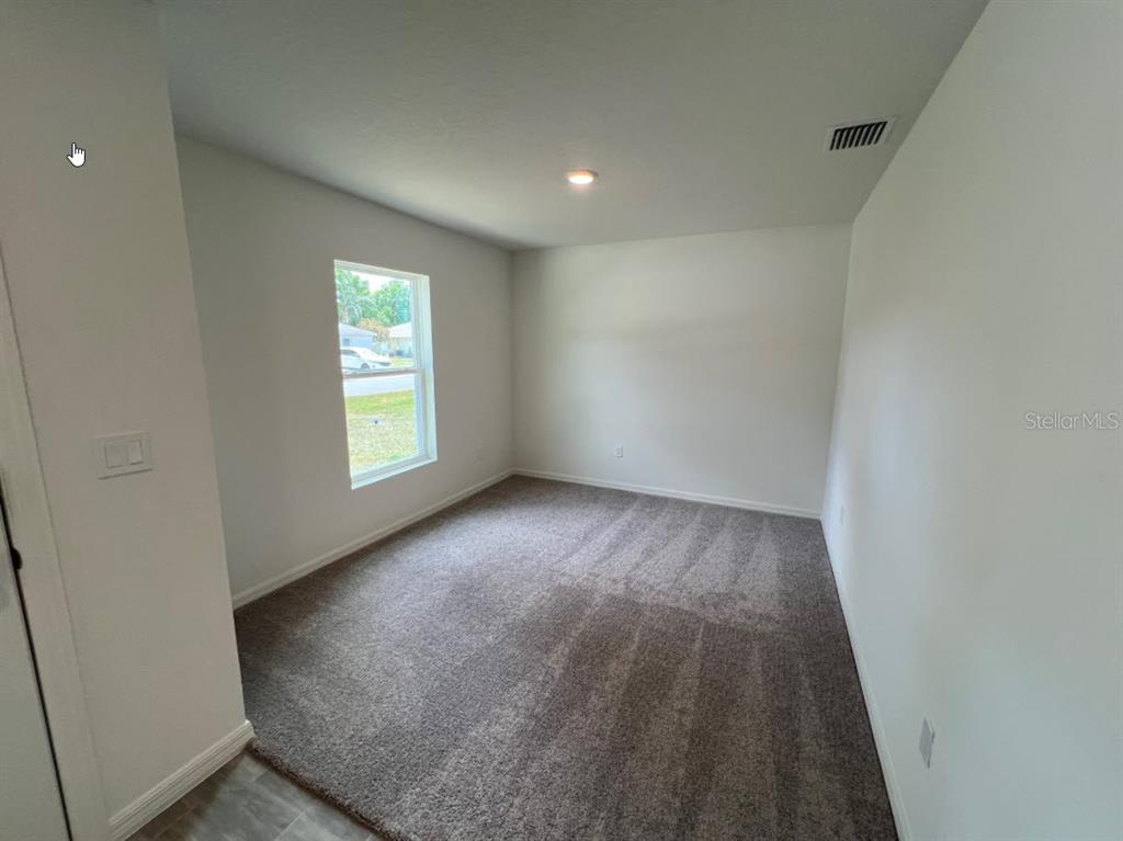 25 Ryding Lane Palm Coast, FL 32164 - Photo 2 of 13 an empty room with windows