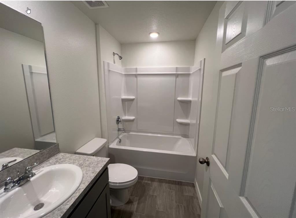 25 Ryding Lane Palm Coast, FL 32164 - Photo 6 of 13 a bathroom with a granite countertop sink toilet and shower