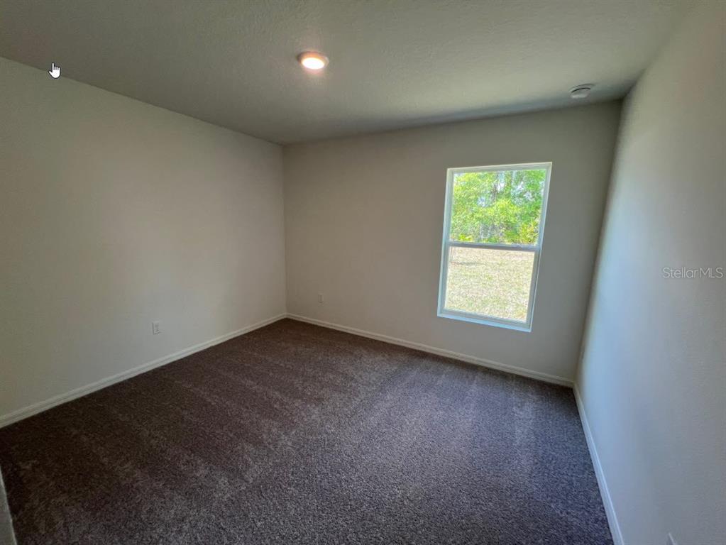25 Ryding Lane Palm Coast, FL 32164 - Photo 7 of 13 an empty room with a window