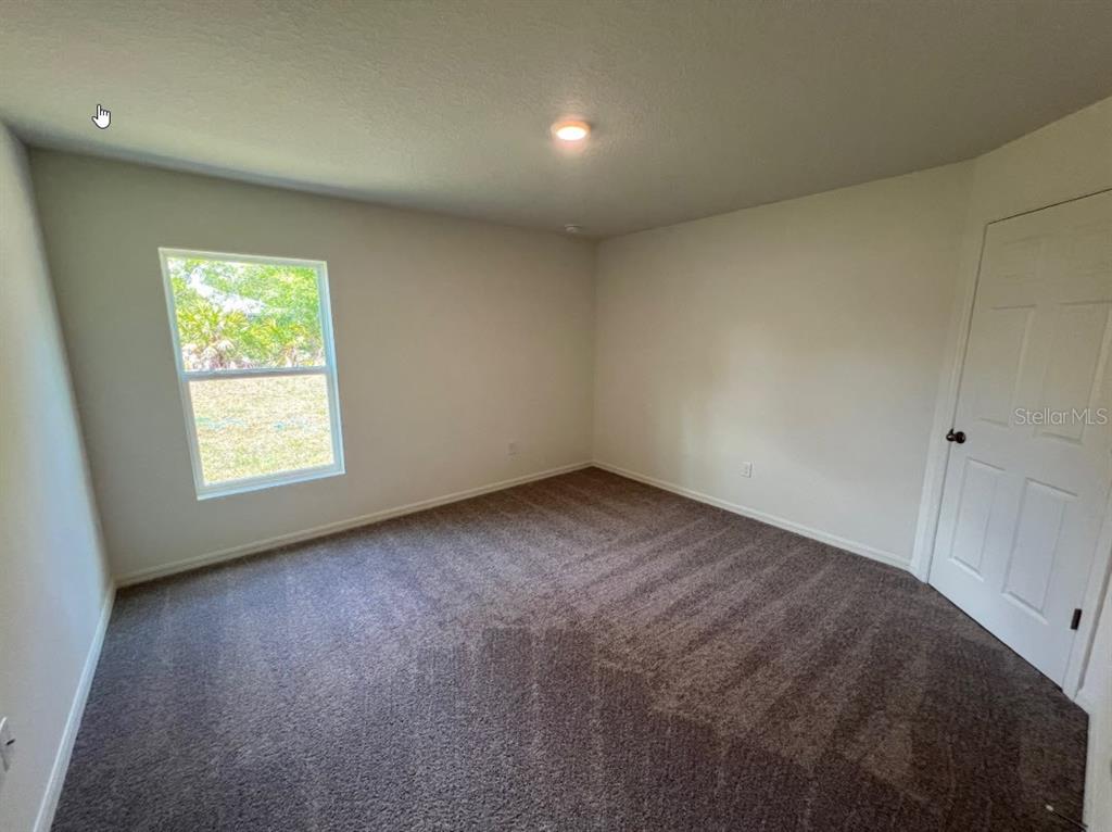 25 Ryding Lane Palm Coast, FL 32164 - Photo 8 of 13 an empty room with a window
