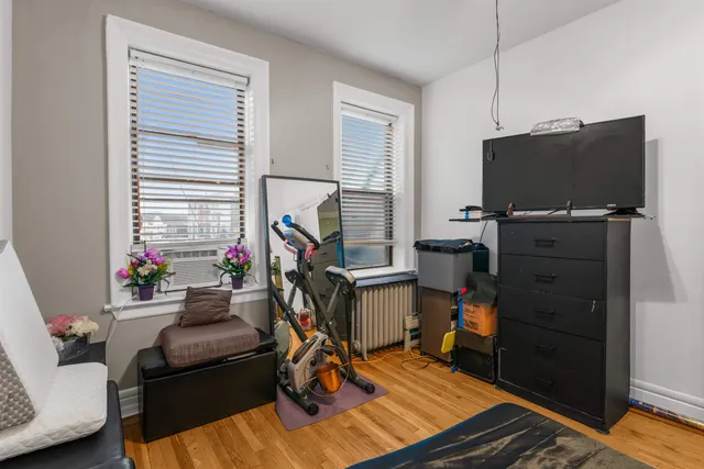 a living room with furniture a flat screen tv and a window