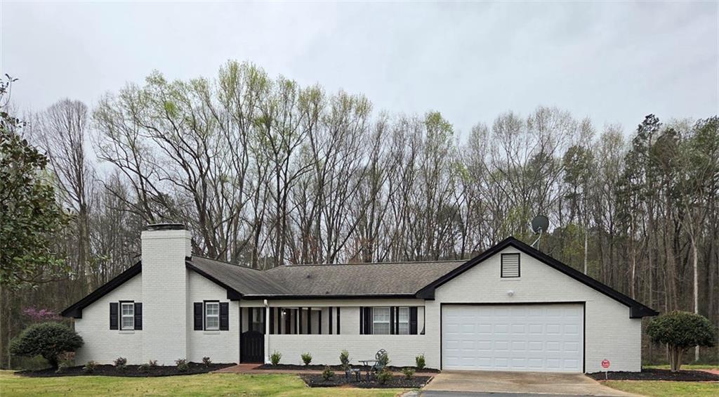 1012 Highway 332 Pendergrass, GA 30567 - Photo 1 of 51 a front view of a house with a yard and trees