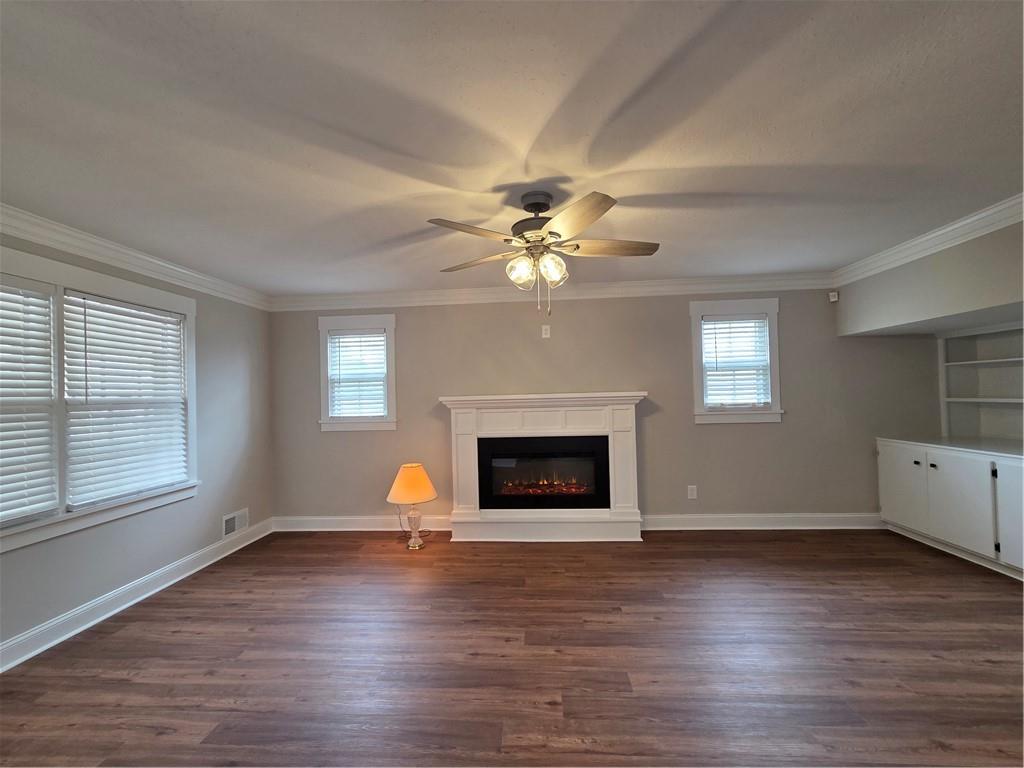 1012 Highway 332 Pendergrass, GA 30567 - Photo 11 of 51 an empty room with wooden floor fireplace and windows
