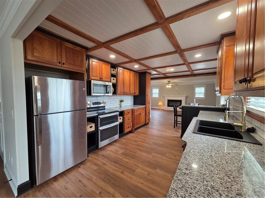 1012 Highway 332 Pendergrass, GA 30567 - Photo 13 of 51 a kitchen with stainless steel appliances granite countertop a refrigerator a stove and a wooden floors