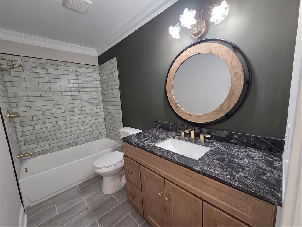 1012 Highway 332 Pendergrass, GA 30567 - Photo 26 of 51 a bathroom with a granite countertop toilet a sink and a mirror