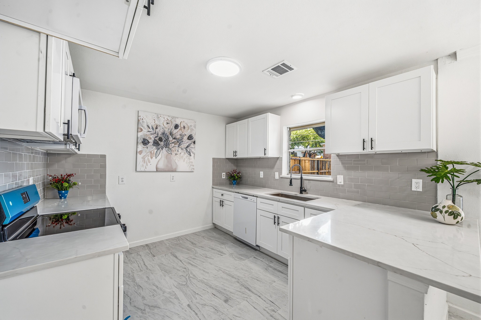111 Princess Drive Houston, TX 77034 - Photo 17 of 30 a kitchen with a white cabinets and window