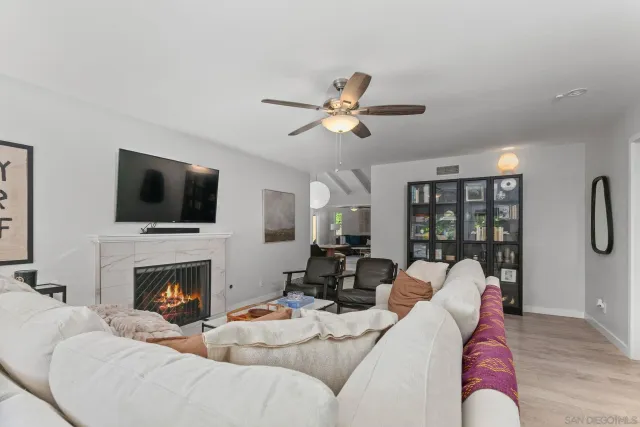 a living room with furniture fireplace and a flat screen tv