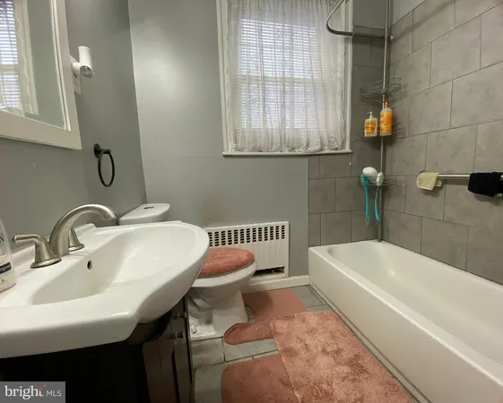 a bathroom with a sink a toilet and bathtub