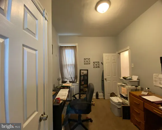 a view of a workspace with furniture and gym equipment