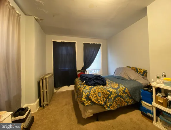 a bedroom with bed and a window