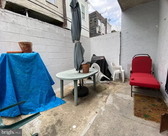 a view of a chairs and table in backyard