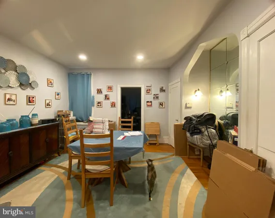 a living room with furniture a lamp and a dining table
