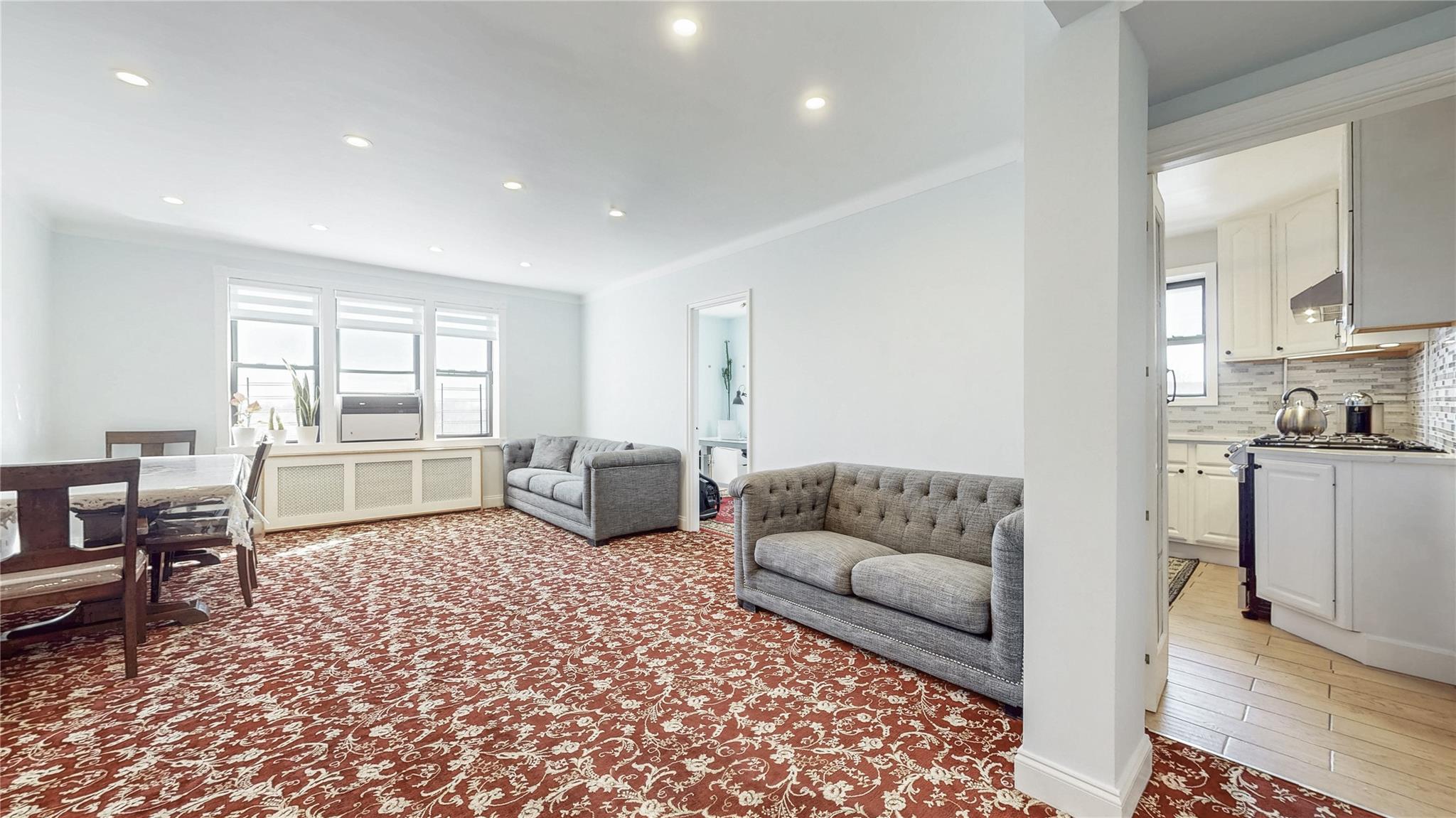 143-50 Hoover Avenue, Unit 507 Queens, NY 11435 - Photo 1 of 24 Living room with radiator heating unit and recessed lighting
