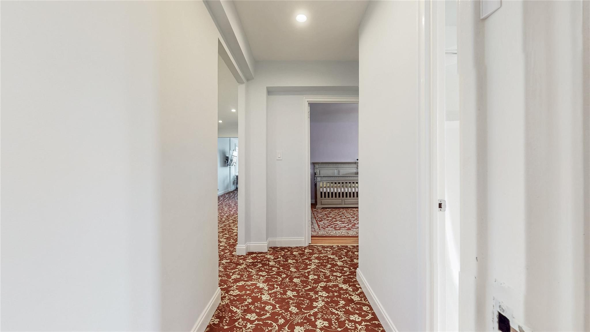143-50 Hoover Avenue, Unit 507 Queens, NY 11435 - Photo 13 of 24 Hallway with baseboards and dark carpet