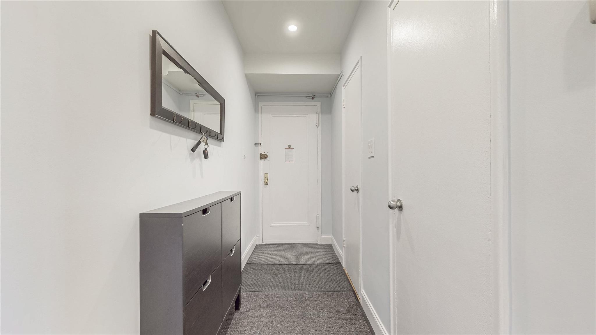 143-50 Hoover Avenue, Unit 507 Queens, NY 11435 - Photo 2 of 24 Corridor with baseboards and dark colored carpet