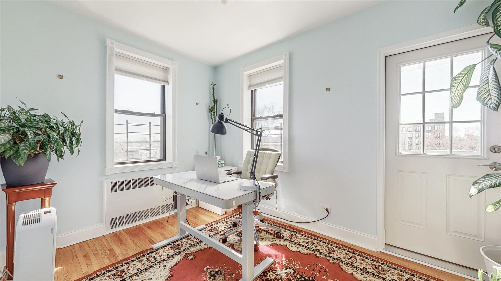143-50 Hoover Avenue, Unit 507 Queens, NY 11435 - Photo 10 of 24 Home office with baseboards, wood finished floors, and radiator heating unit