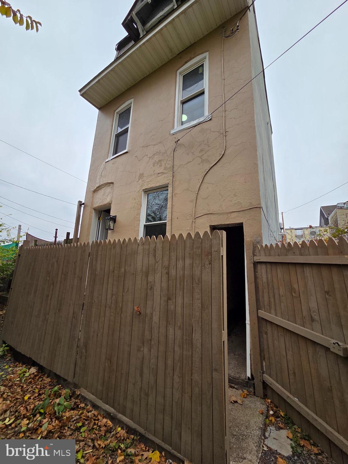a front view of a house with wooden fence