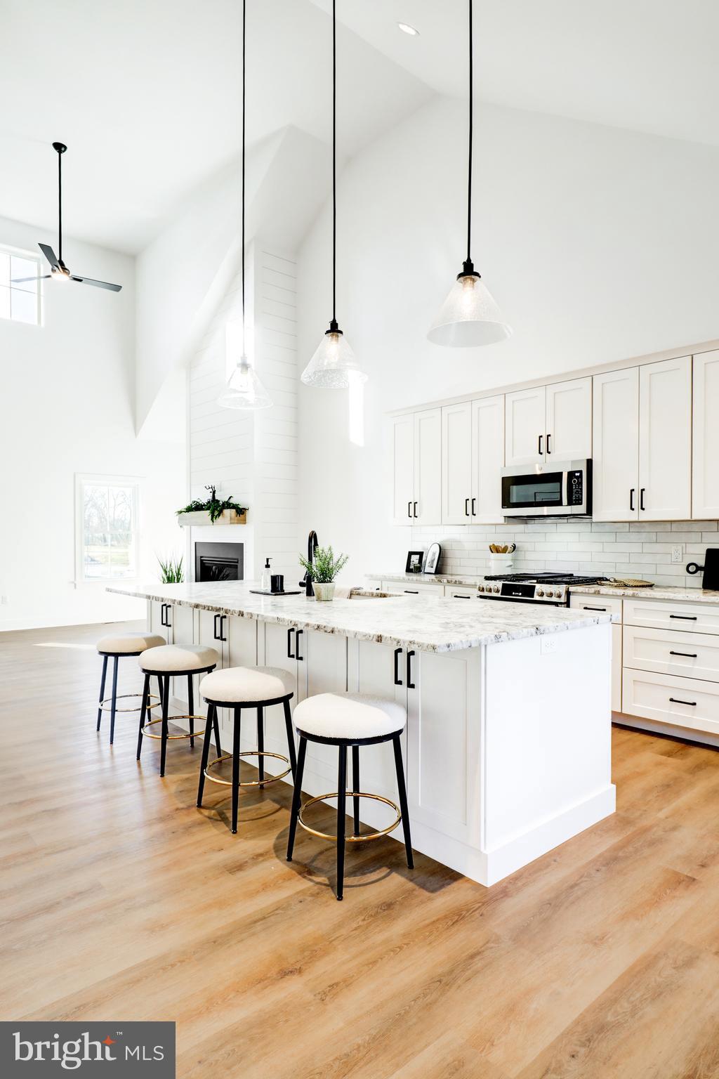 220 Parkside Place Lancaster, PA 17602 - Photo 17 of 49 a kitchen with stainless steel appliances kitchen island granite countertop a table chairs stove and white cabinets