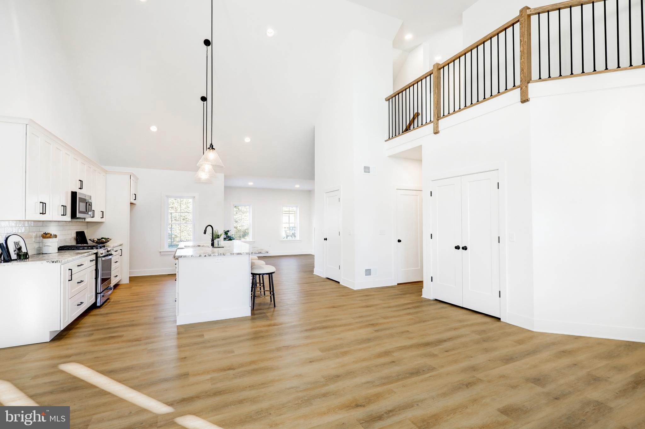 220 Parkside Place Lancaster, PA 17602 - Photo 4 of 49 a kitchen with stainless steel appliances kitchen island wooden floors and white cabinets