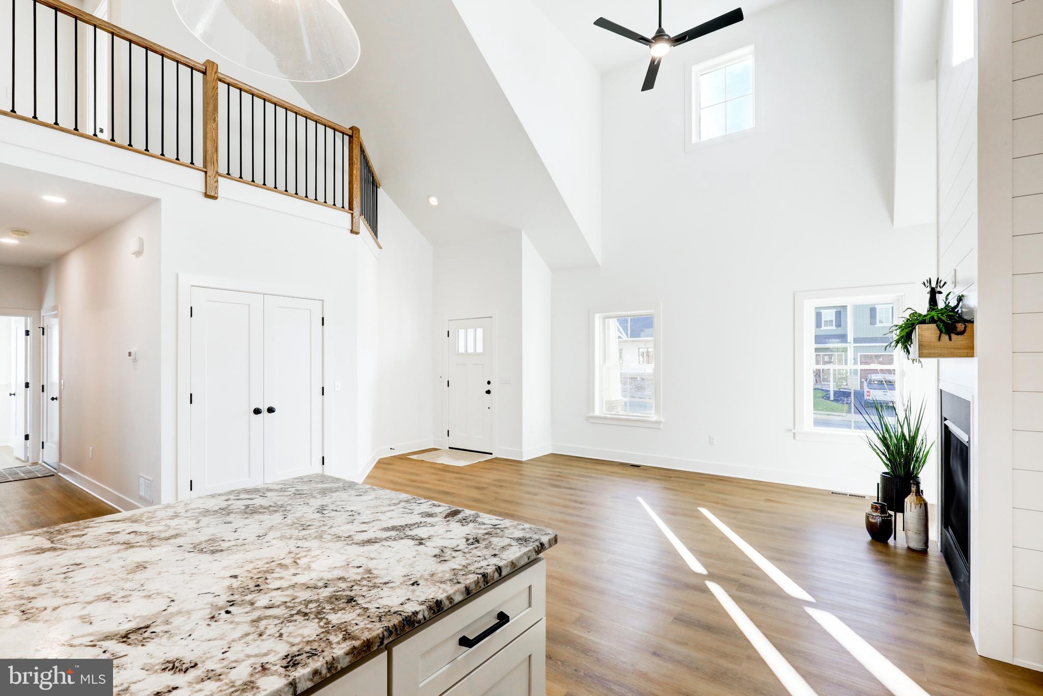 220 Parkside Place Lancaster, PA 17602 - Photo 6 of 49 a view of a hallway to a livingroom with wooden floor and a ceiling fan