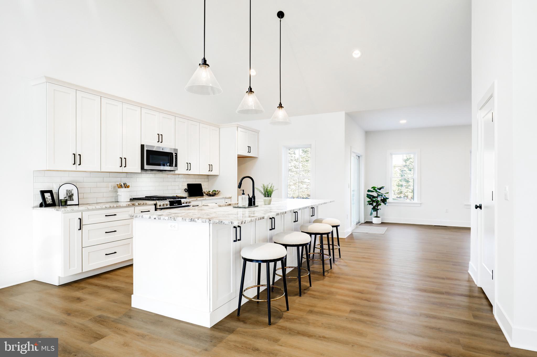 220 Parkside Place Lancaster, PA 17602 - Photo 7 of 49 a large white kitchen with lots of counter space a sink appliances and living room view