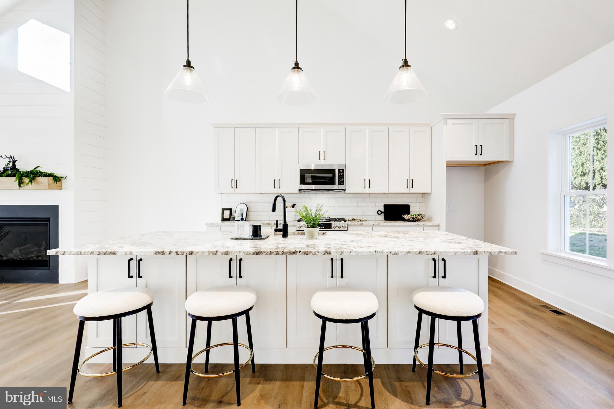220 Parkside Place Lancaster, PA 17602 - Photo 8 of 49 a kitchen with stainless steel appliances a white table and chairs in it