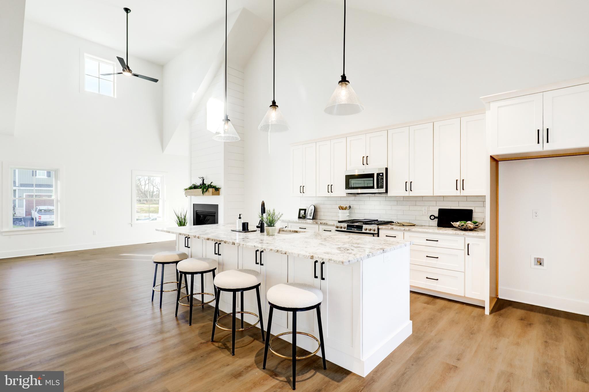220 Parkside Place Lancaster, PA 17602 - Photo 10 of 49 a kitchen with stainless steel appliances a dining table chairs stove and white cabinets